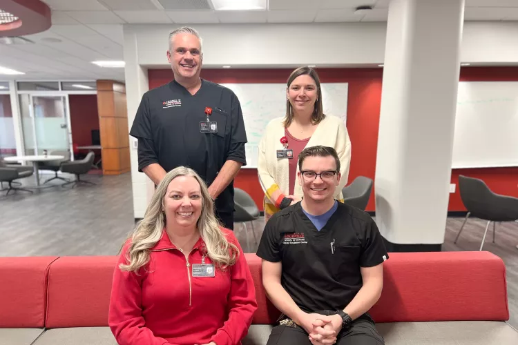 University of Louisville School of Nursing faculty and staff simulation team post for a photo in the Student Collaboration Center. Simulation Center Director Chris Pennington,  Brett Kendon, Cristin Whitaker, and Mark Stewart are pictured.