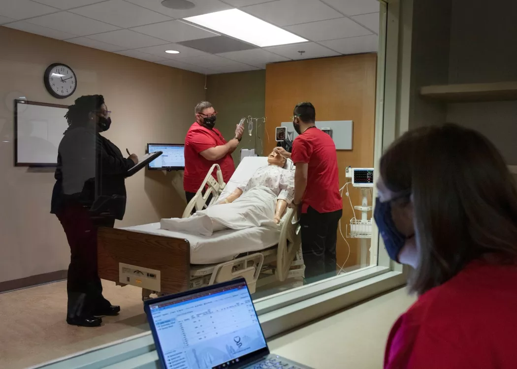 Students assess a manikin in a simulation experience in the Clinical Simulation Center at the UofL School of Nursing Louisville Owensboro Extension.